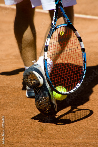 tennis shoes and raquet in action