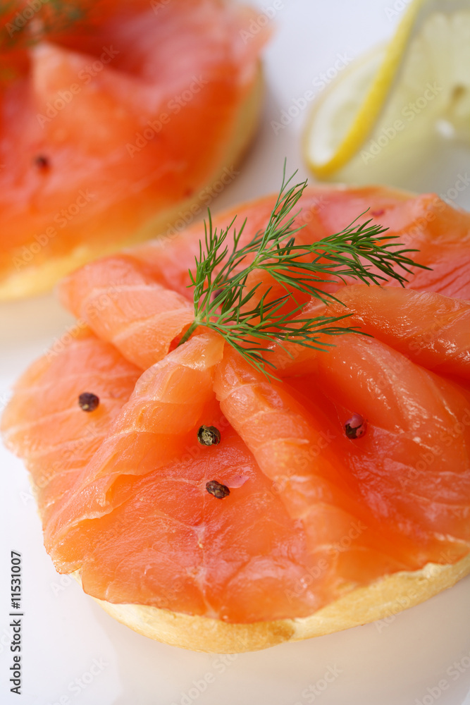 Smoked salmon on bagel with fresh black pepper. Smoked salmon on bagel with fresh black pepper.