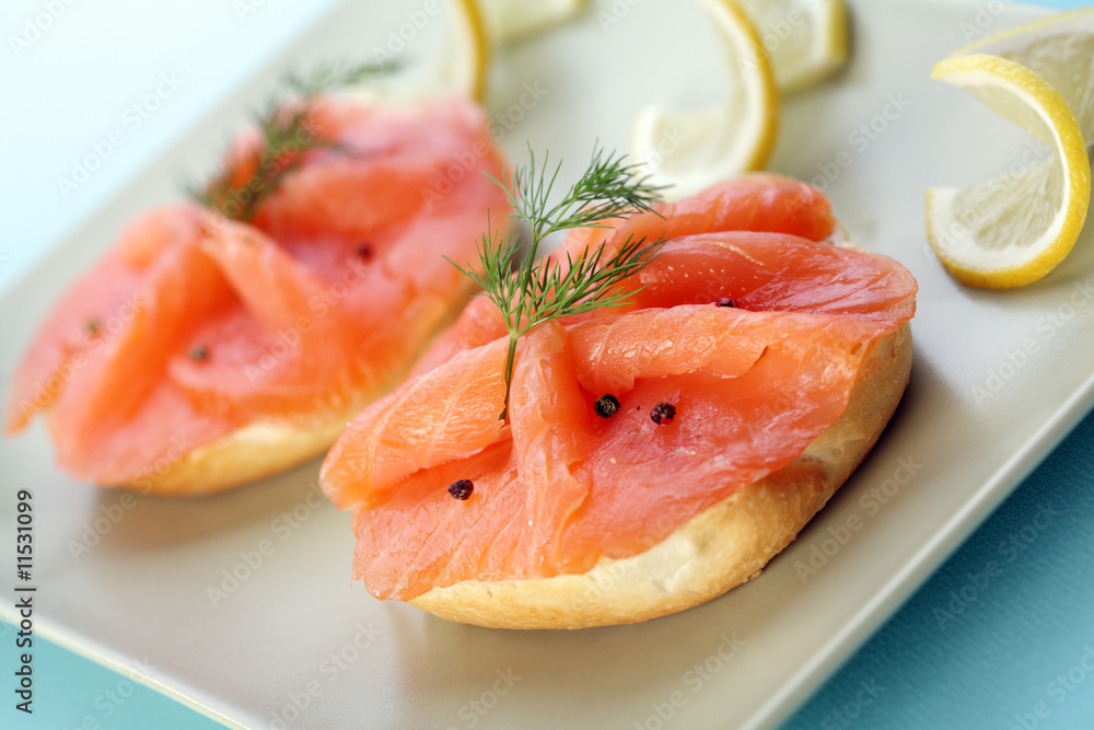 Smoke salmon on bagel with freshly black pepper.