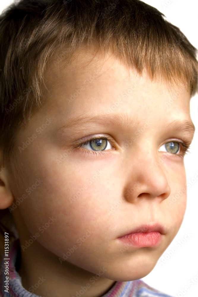 Face of serious boy isolated over white background Face of serious boy isolated over white background