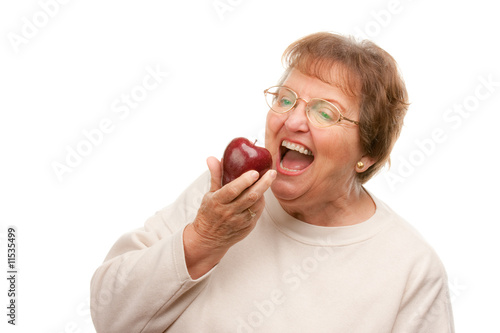 Hungry Senior Woman Eats Ap...