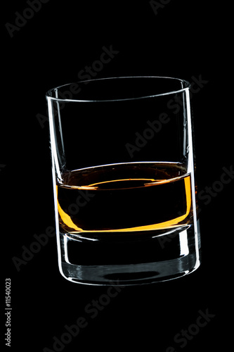 glass of whiskey isolated over black background