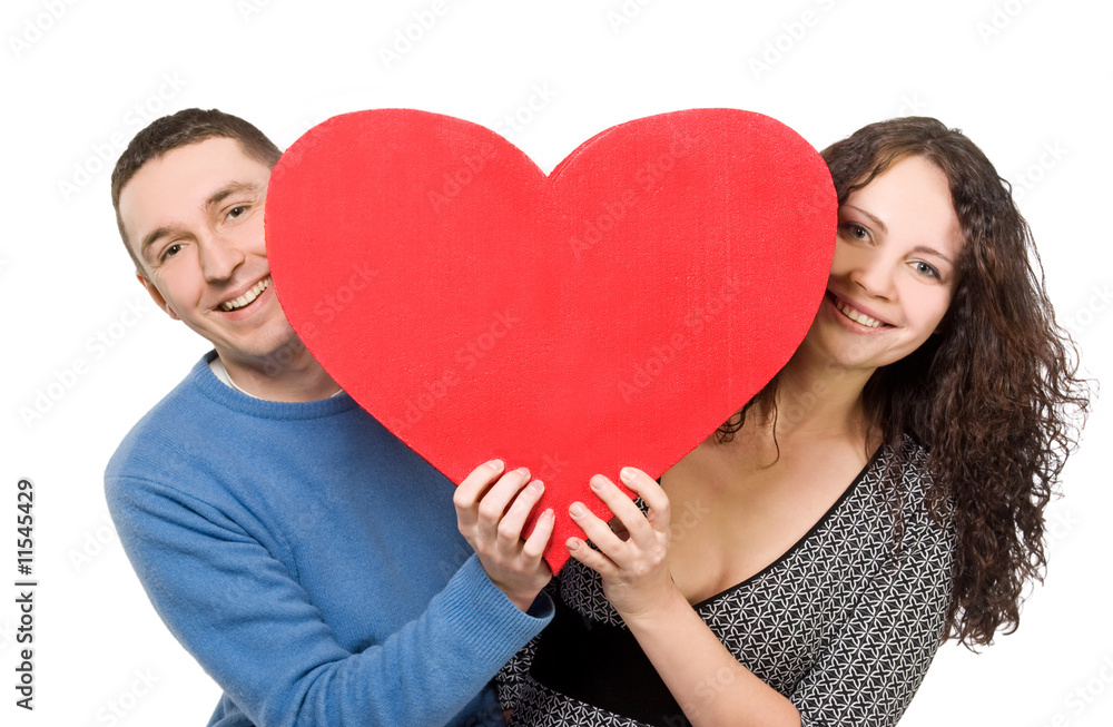 smiling loving couple holding heart