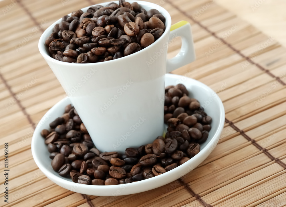 Cup with coffee beans Cup with coffee beans