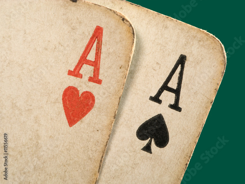 2 old dirty aces poker cards close up. photo