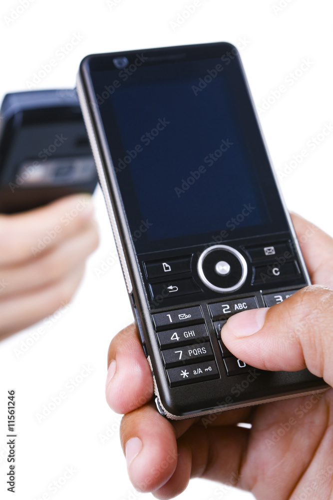 Hand using a mobile phone and the other in background Hand using a mobile phone and the other in background