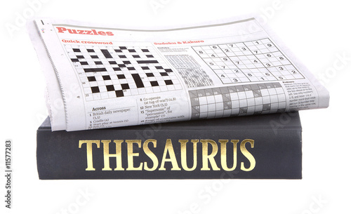 Newspaper crossword on top of a thesaurus photo