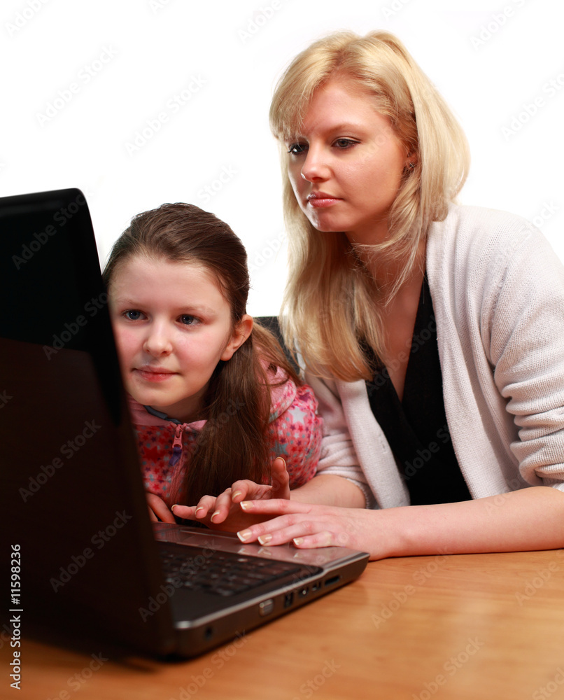 Mother Helping Child with School work on a Laptop Mother Helping Child with School work on a Laptop