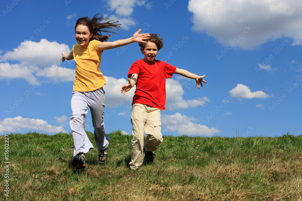 Kids jumping, running against blue sky Kids jumping, running against blue sky