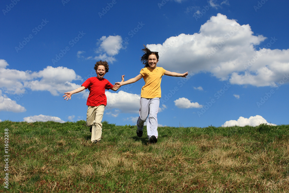 Kids jumping, running against blue sky Kids jumping, running against blue sky