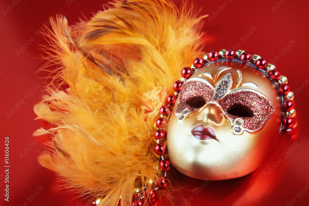 ornate carnival mask over textured metallic background