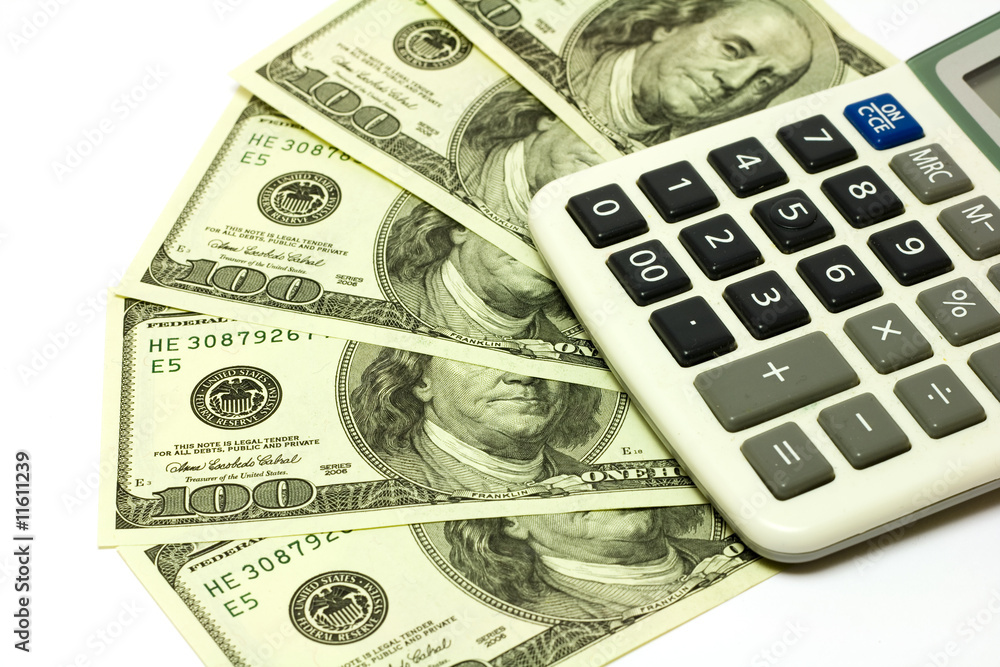 One hundred dollar banknotes and calculator One hundred dollar banknotes and calculator