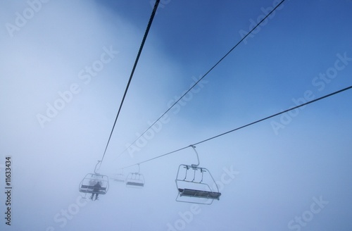 Chairlift disappearing into fog