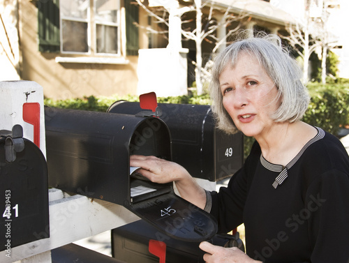 Mature Woman at Mailbox Talking to her Neighbor