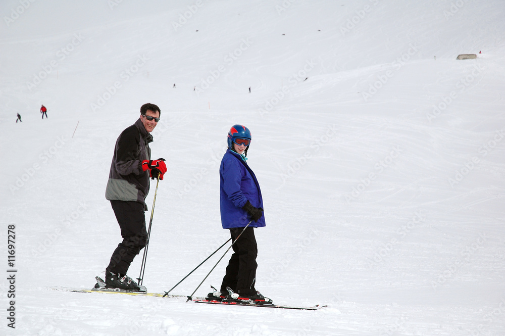 father and daughter skiing