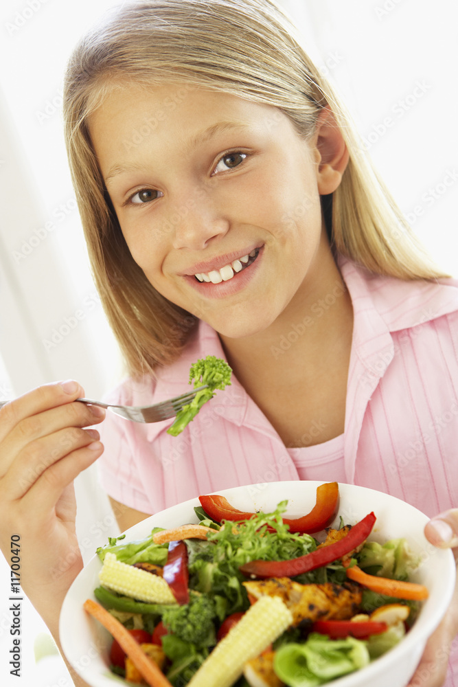 Young Girl Eating Fresh Salad