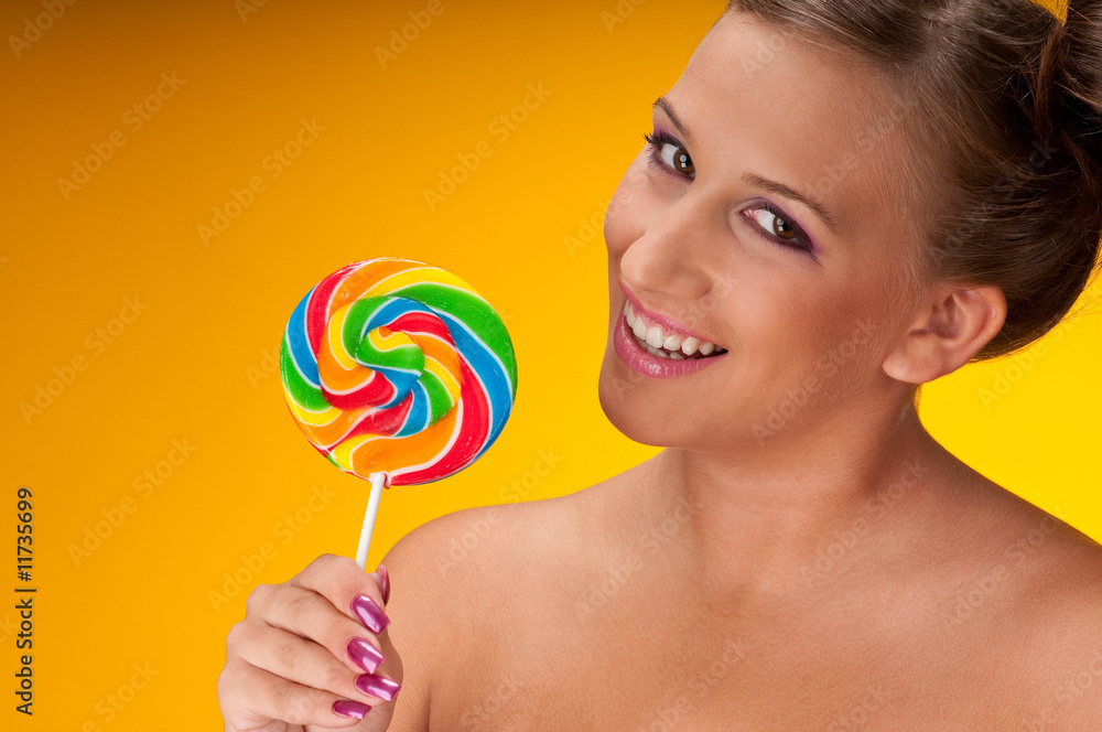 Smiling brunette with big lollipop
