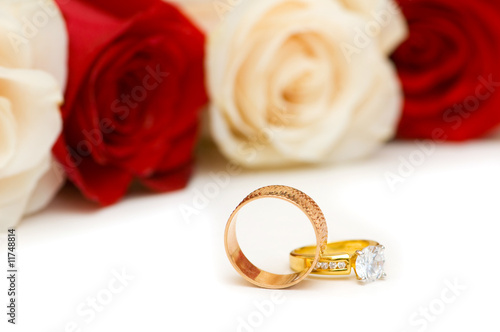 Golden rings and roses isolated on the white