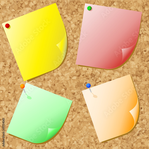 Different coloured post-it notes on cork noticeboard