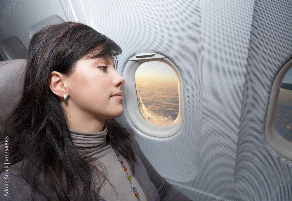 Obraz premium young woman is on passenger seat at airplane