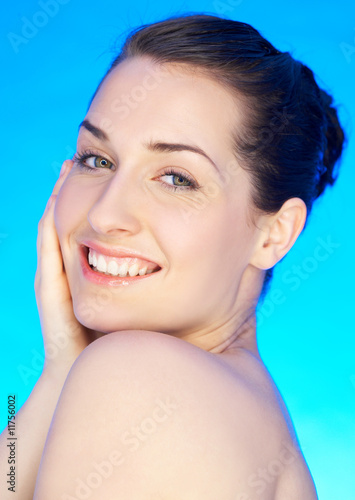 Portrait of 20-25 years old beautiful woman on blue background