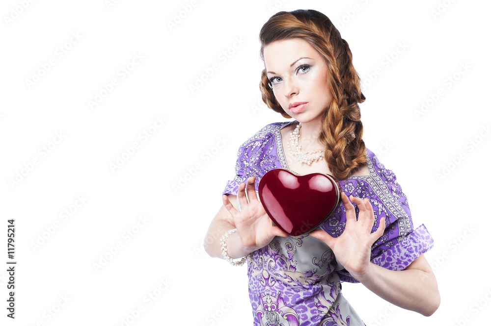 Beautiful romantic woman holding a dark red heart