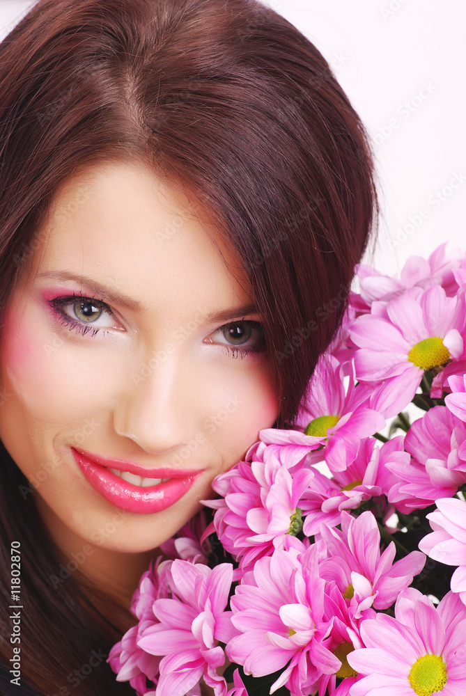 Attractive young woman face with flowers