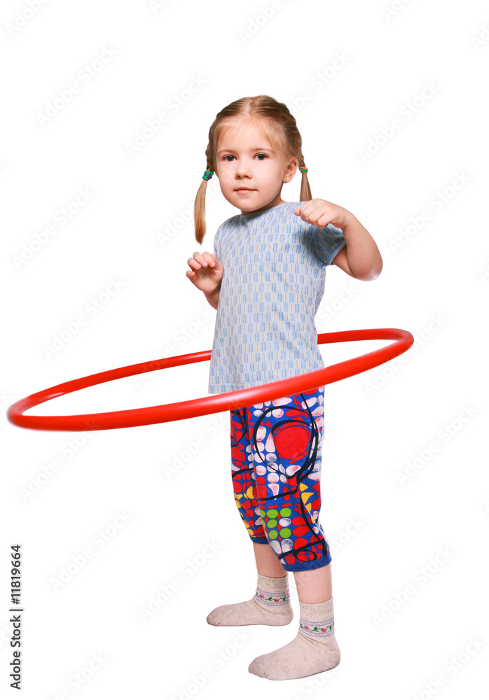 The girl rotates a gymnastic hoop