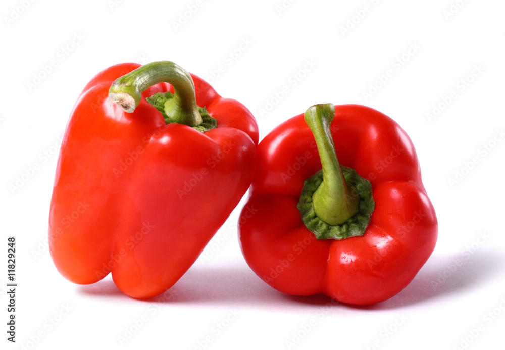 Two big red peppers on white