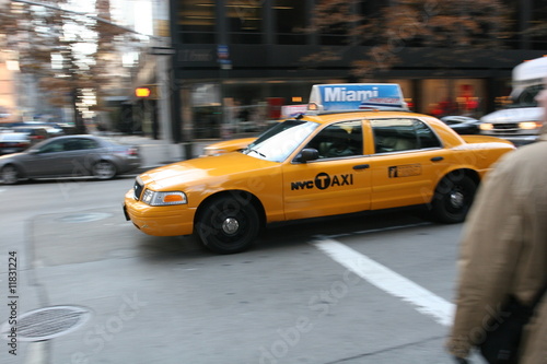 Fast driving yellow cab (Taxi car) in Manhattan Soho in New York City, USA