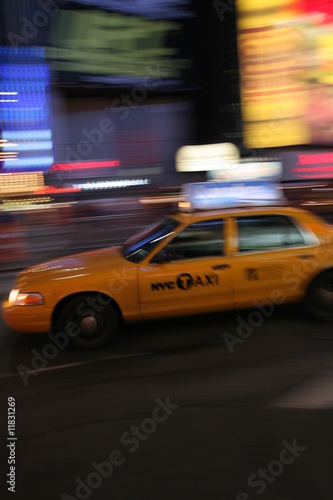 Fast driving yellow cab (Taxi car) in Manhattan at night on Times Square, New York City, USA