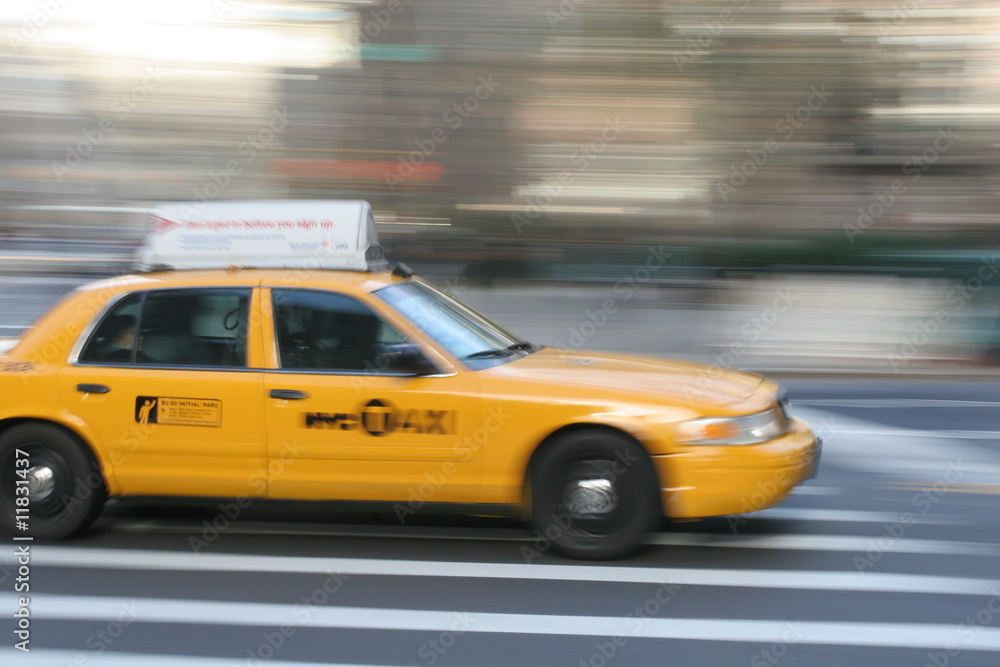 Fast driving yellow cab (Taxi car) in Manhattan on Fifth Avenue, New York City, USA