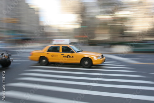 Fast driving yellow cab  Taxi car  in Manhattan on Fifth Avenue  New York City  USA