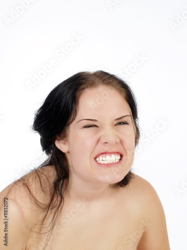 Young woman with exaggerated facial expression snarl