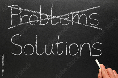 Crossing out problems and writing solutions on a blackboard.