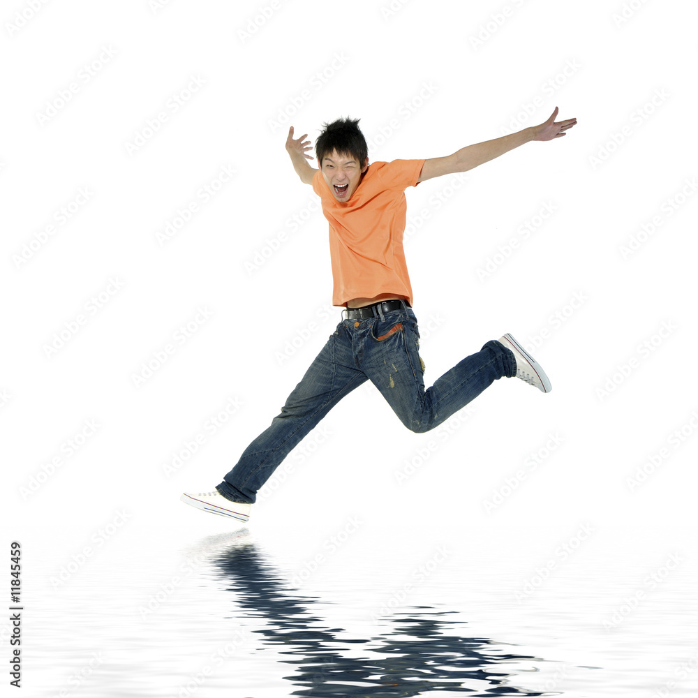 Asian young adult jumping in the air with reflection Asian young adult jumping in the air with reflection