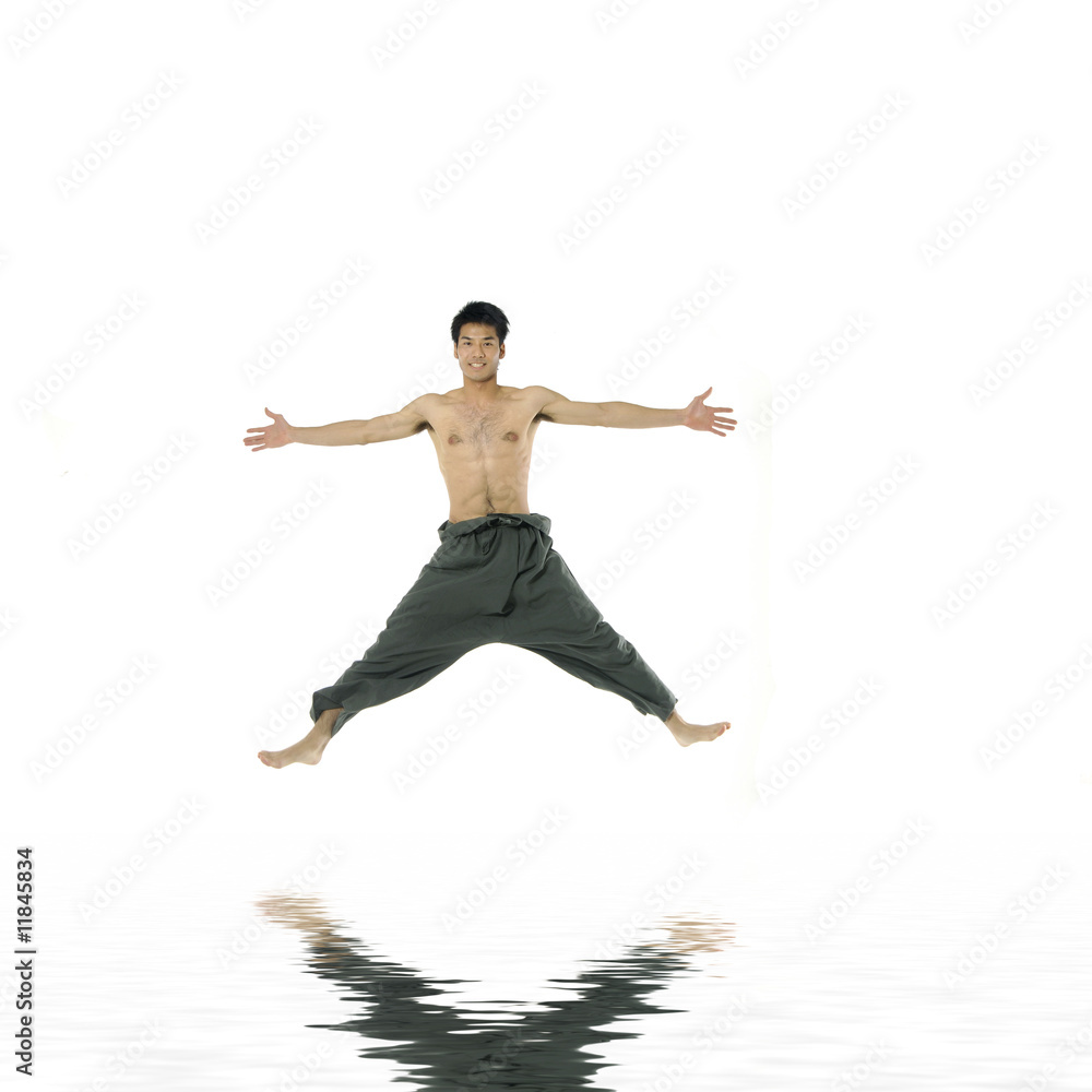 Attractive Young man flying in the air. with reflection