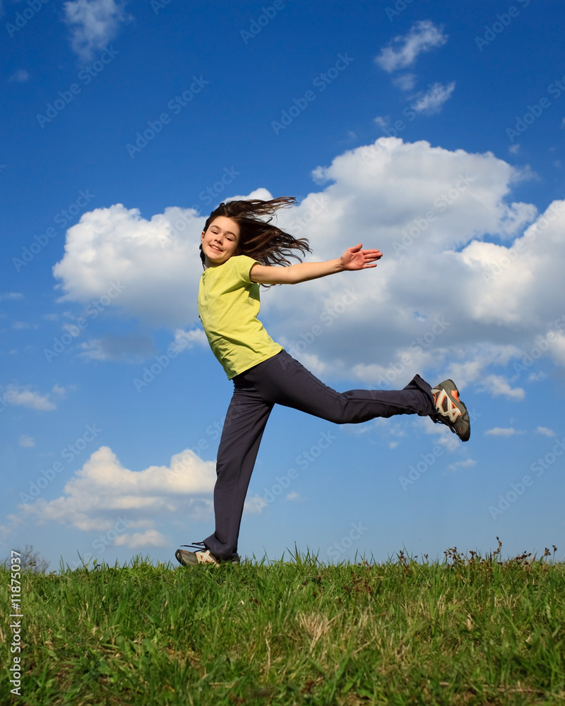Girl jumping, running outdoor against blue sky Girl jumping, running outdoor against blue sky