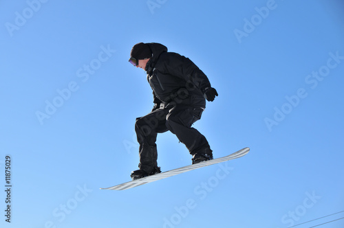 youth on snow board performing aerial skiing