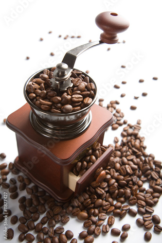 old-fashioned coffee grinder and roasted coffee beans isolated