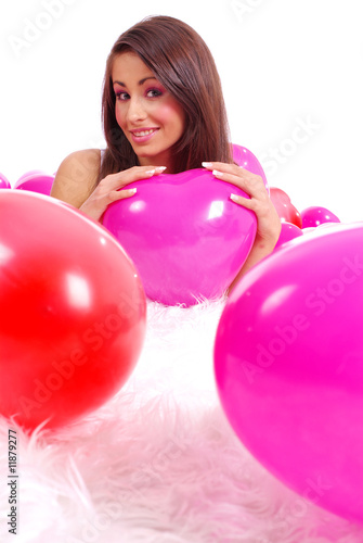 sexy girl lying on floor among balloons