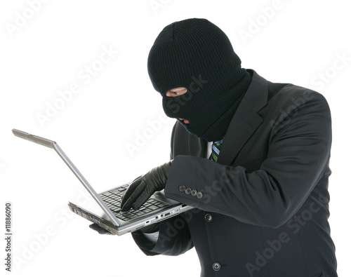 Computer criminal - Hacker with laptop computer