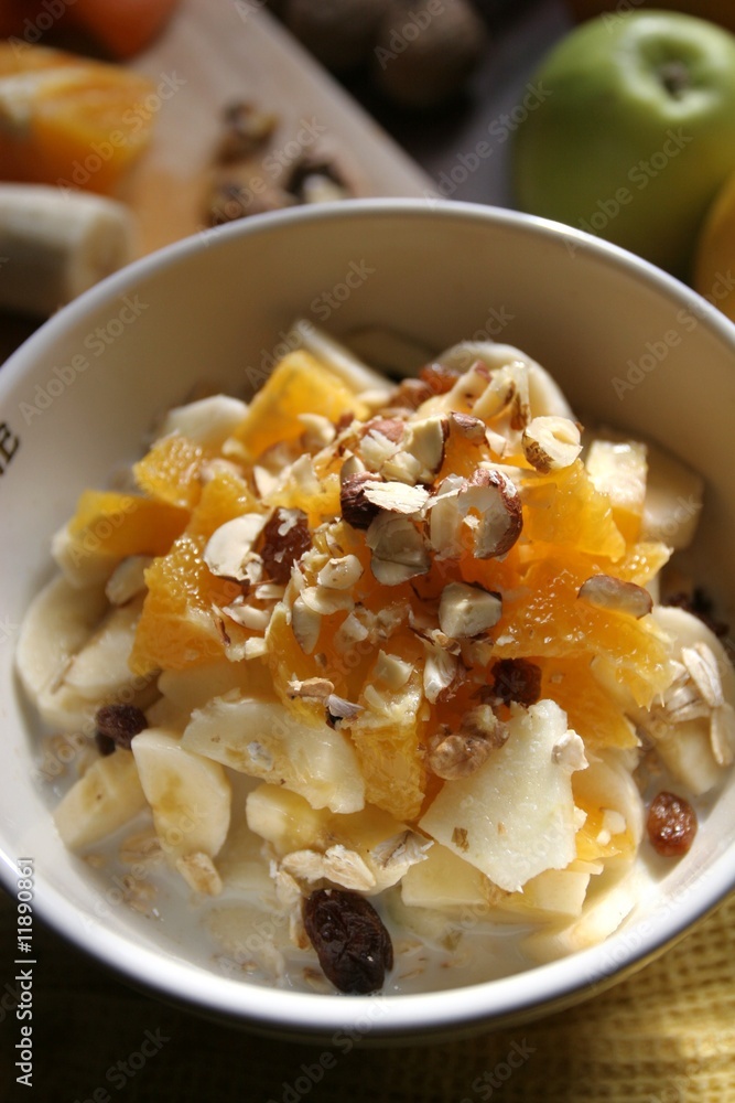 Still-life of a Bircher Muesli with fresh fruits, honey and hazelnuts in a morning light atmosphere taken on a kitchen table, close-up Still-life of a Bircher Muesli with fresh fruits, honey and hazelnuts in a morning light atmosphere taken on a kitchen table, close-up