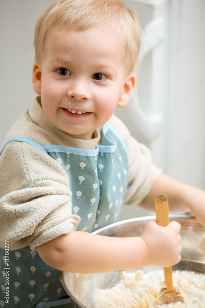 Delighted boy mixed the dough. Delighted boy mixed the dough.