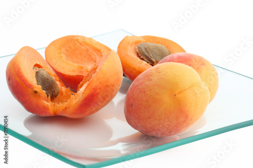 Isolated fresh apricots in a glass plate