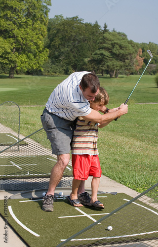 Dad Teaching Son Golf