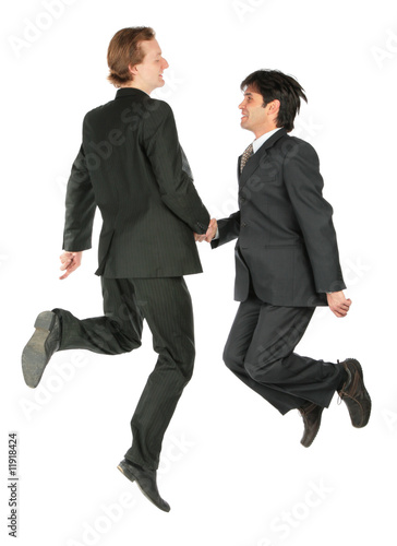 Two businessmen jump