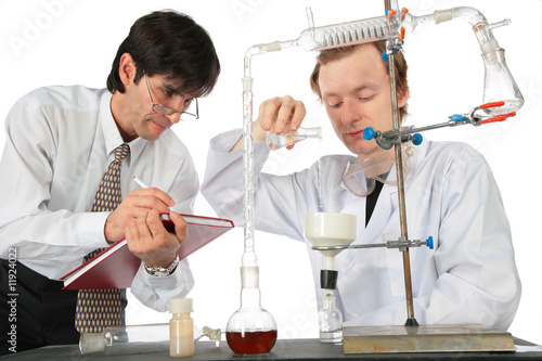 Two scientists do chemical experiment