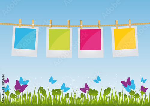 Photo Prints hanging on a rope on field background