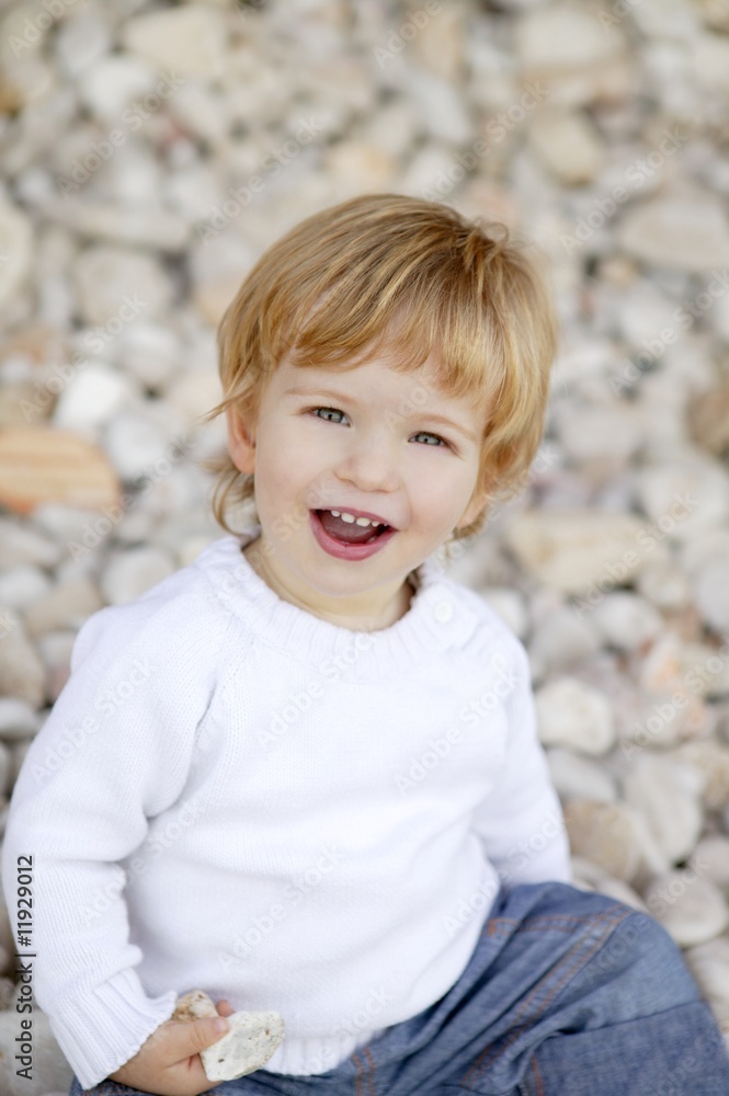 Blond boy smiling on a rolling stones background Blond boy smiling on a rolling stones background